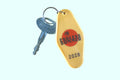 Yellow Endless Summer 2026 motel keychain with silver key on pale background