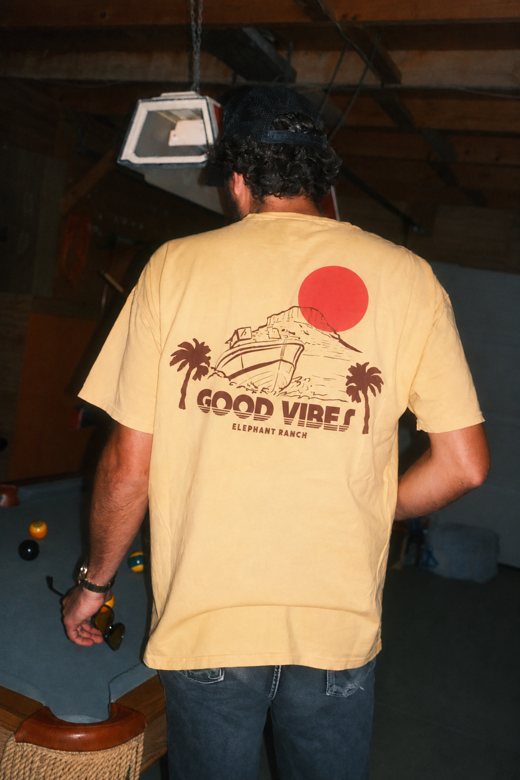 Good Vibes Elephant Ranch tee featuring retro boat and sunset graphic